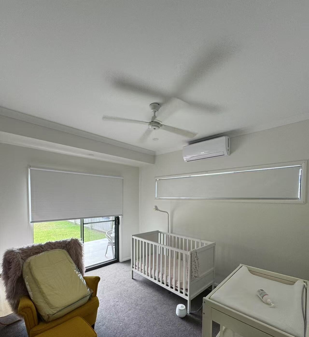 White blockout roller blinds installed for sliding door and window in child room