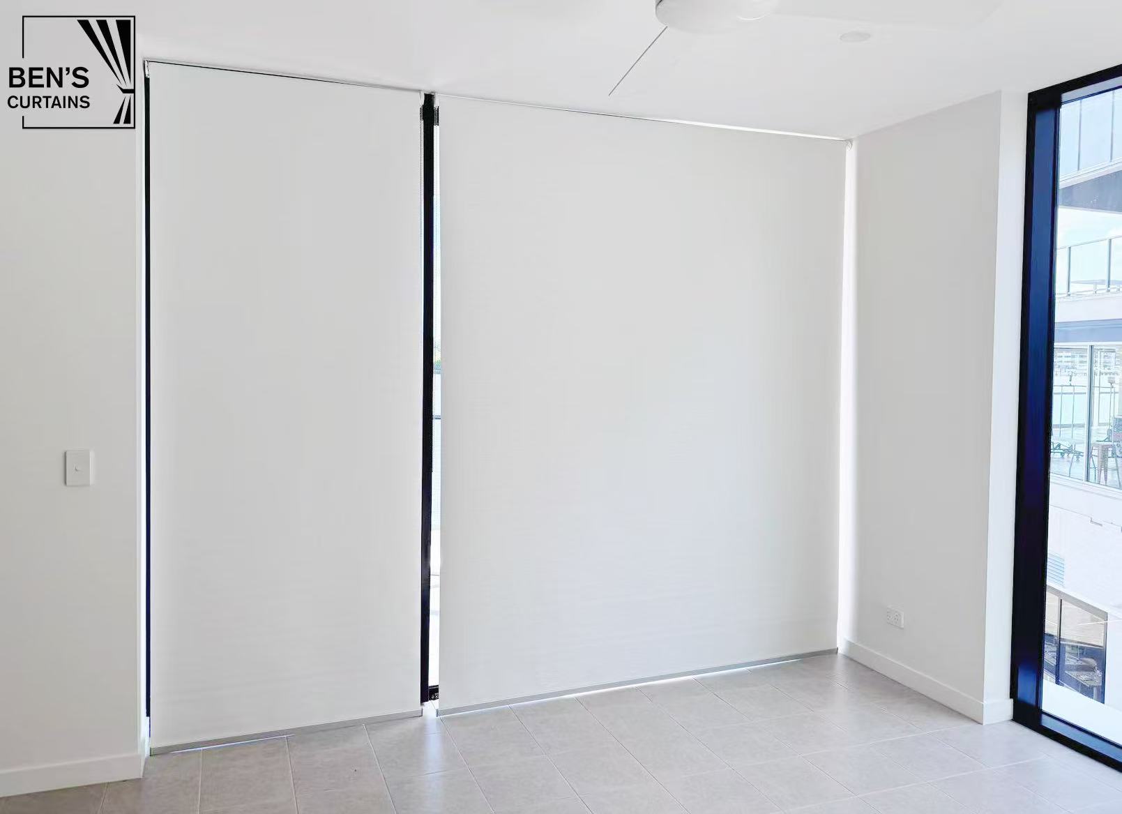 White blockout roller blinds installed on three panel sliding doors