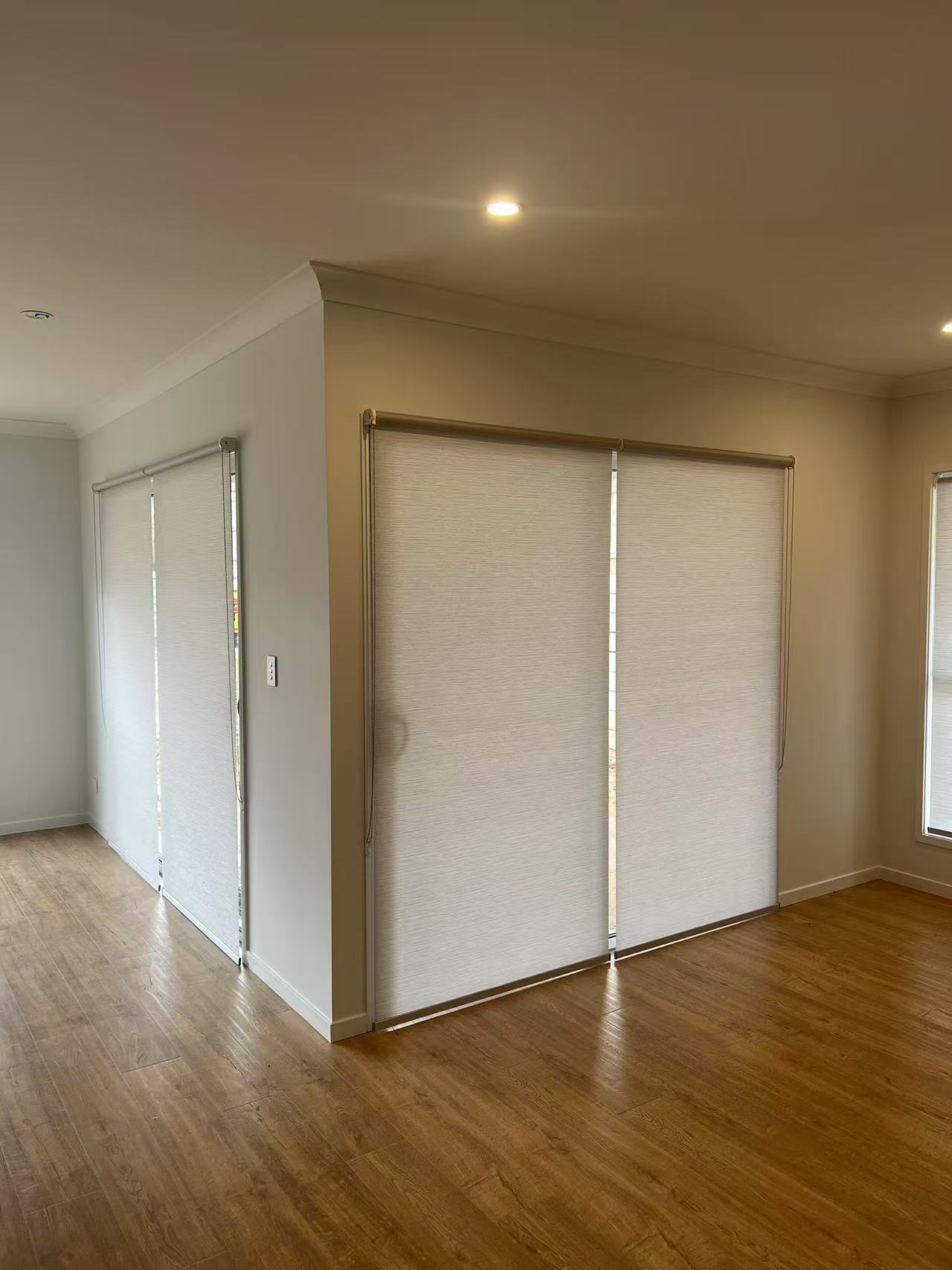 Light filtering privacy grey roller blinds installed for two sliding doors in alfresco are