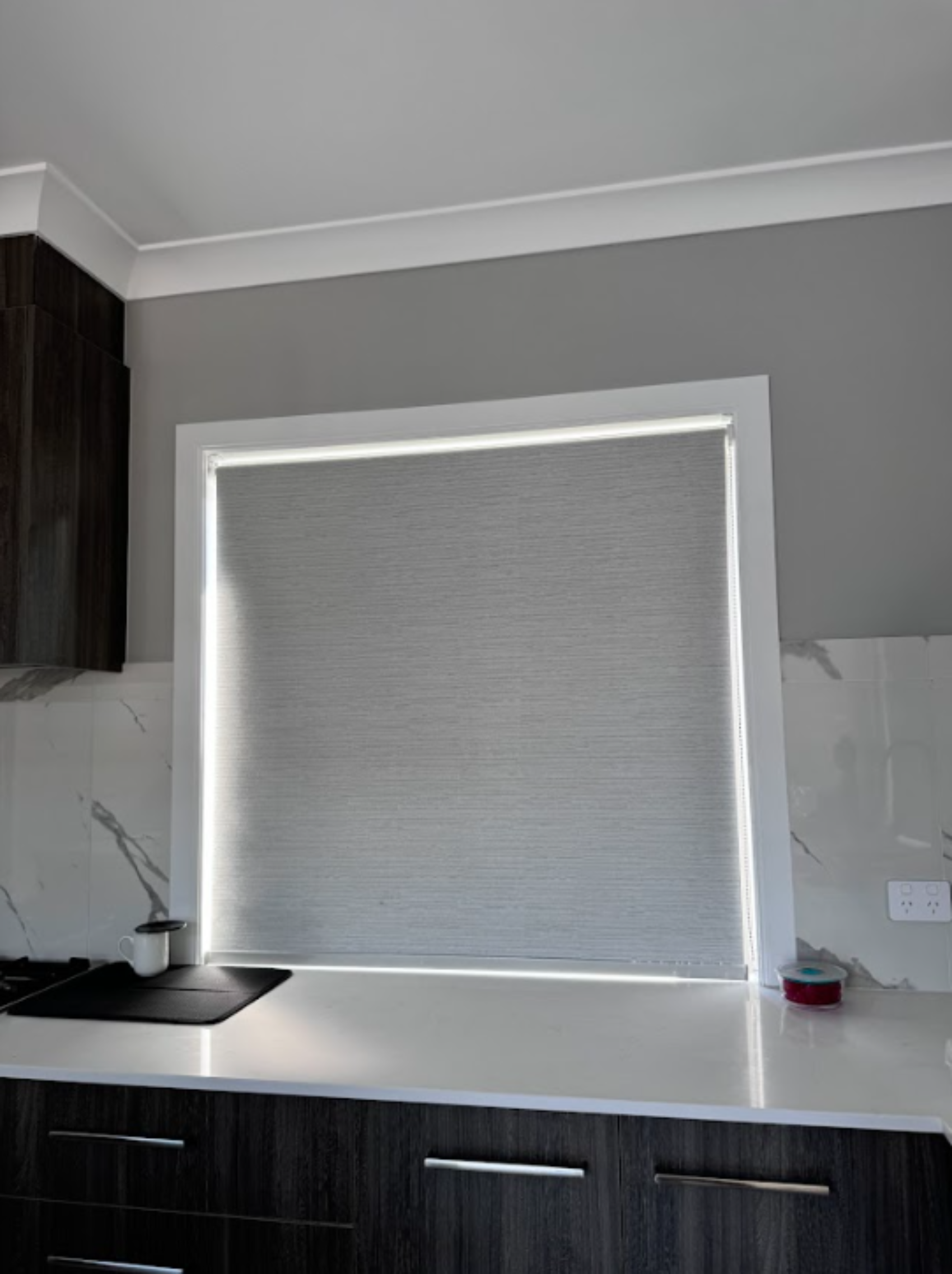 Grey blockout roller blind for kitchen window