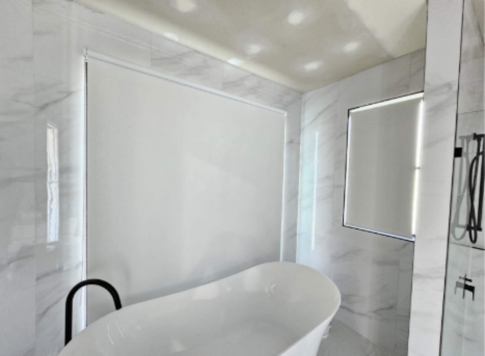 White blockout roller blinds installed in bathroom