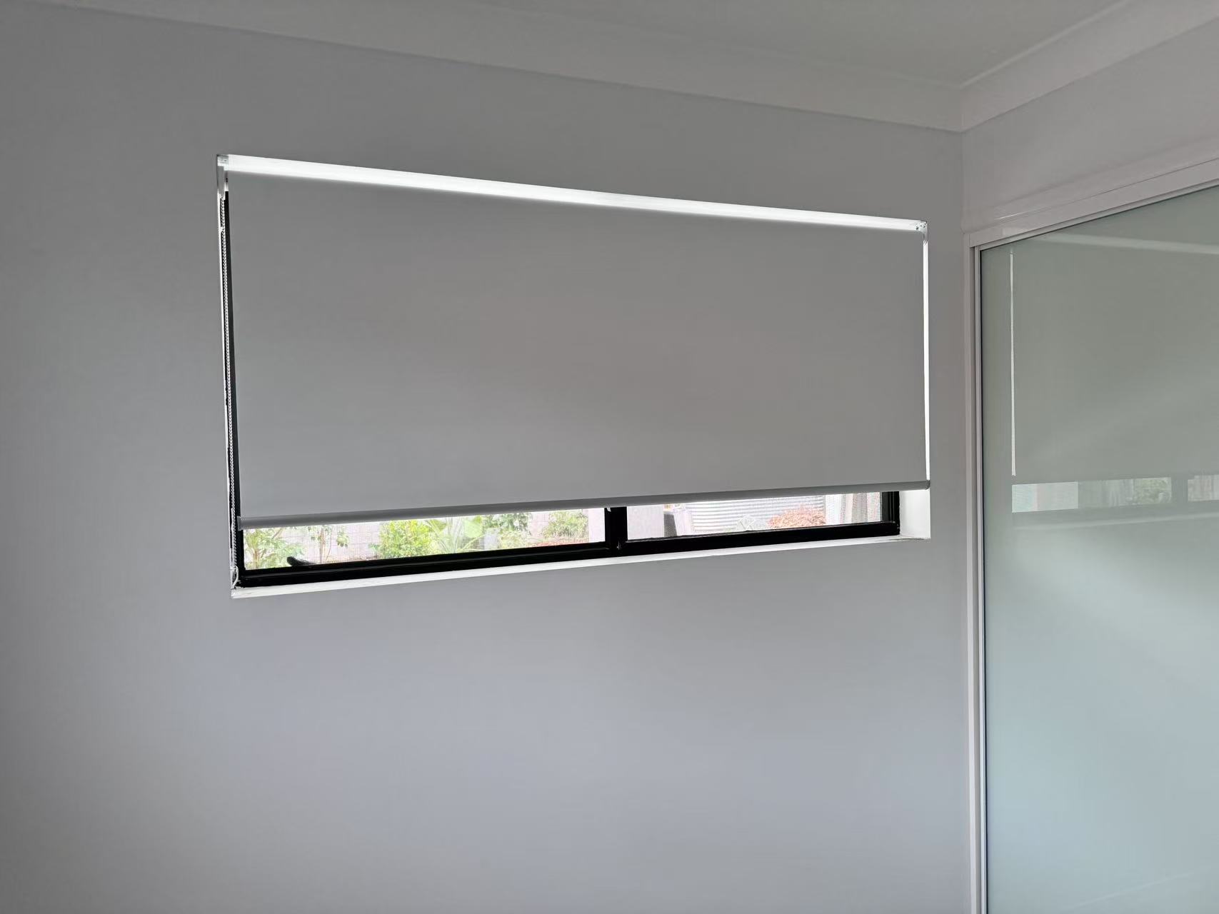 White blockout roller blinds installed within the window frame
