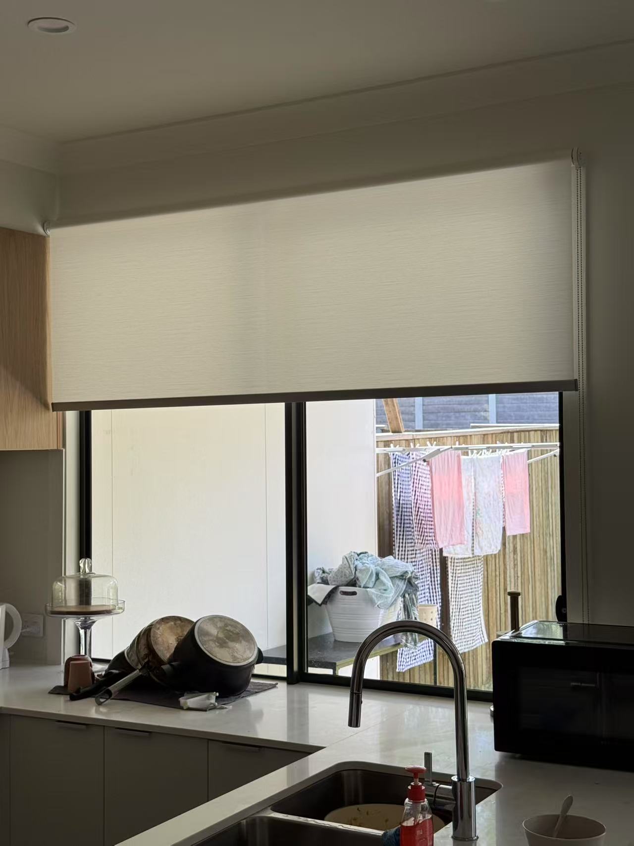 Light filtering privacy roller blind installed in the kitchen