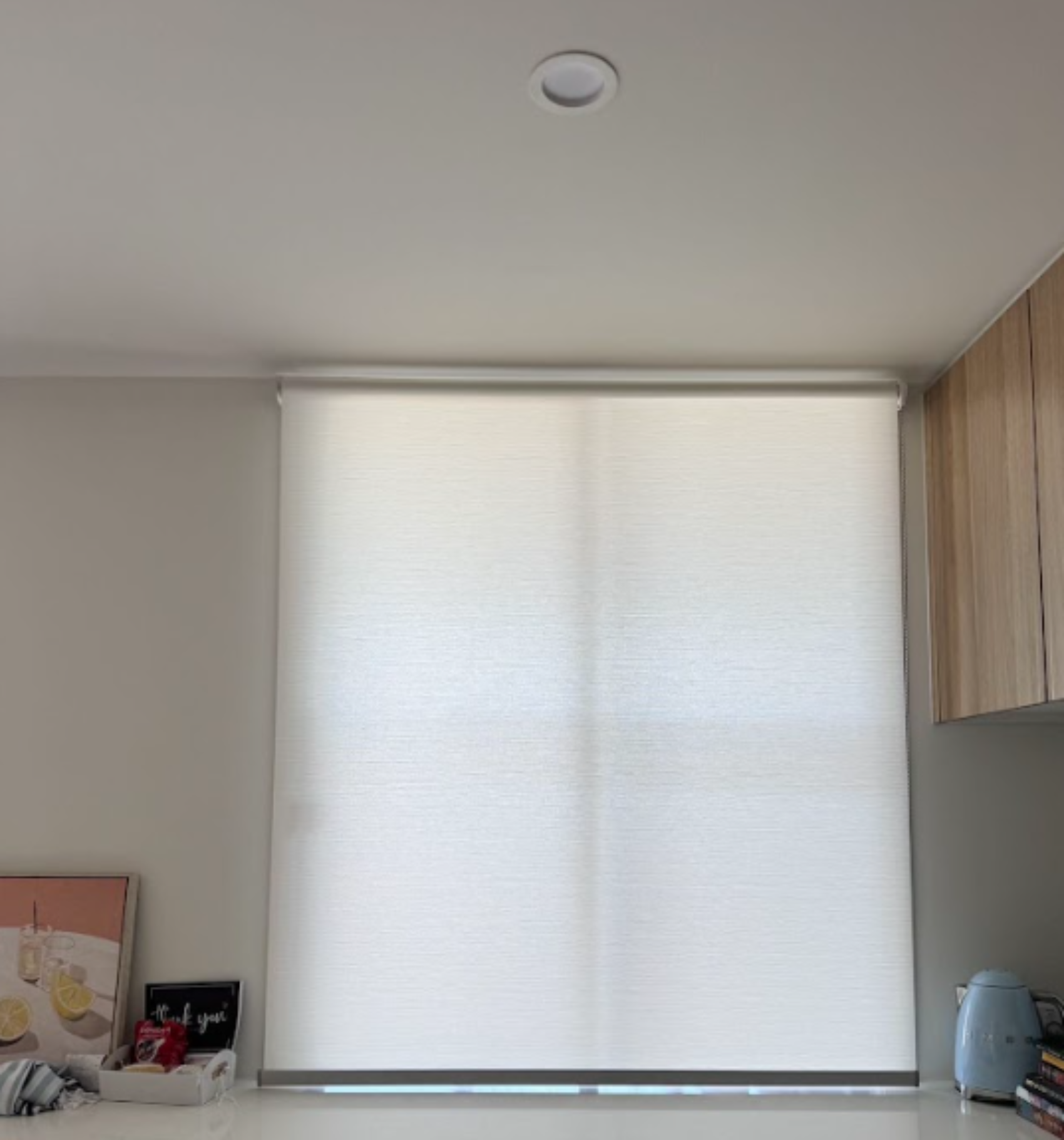 White light filtering privacy roller blind installed in kitchen