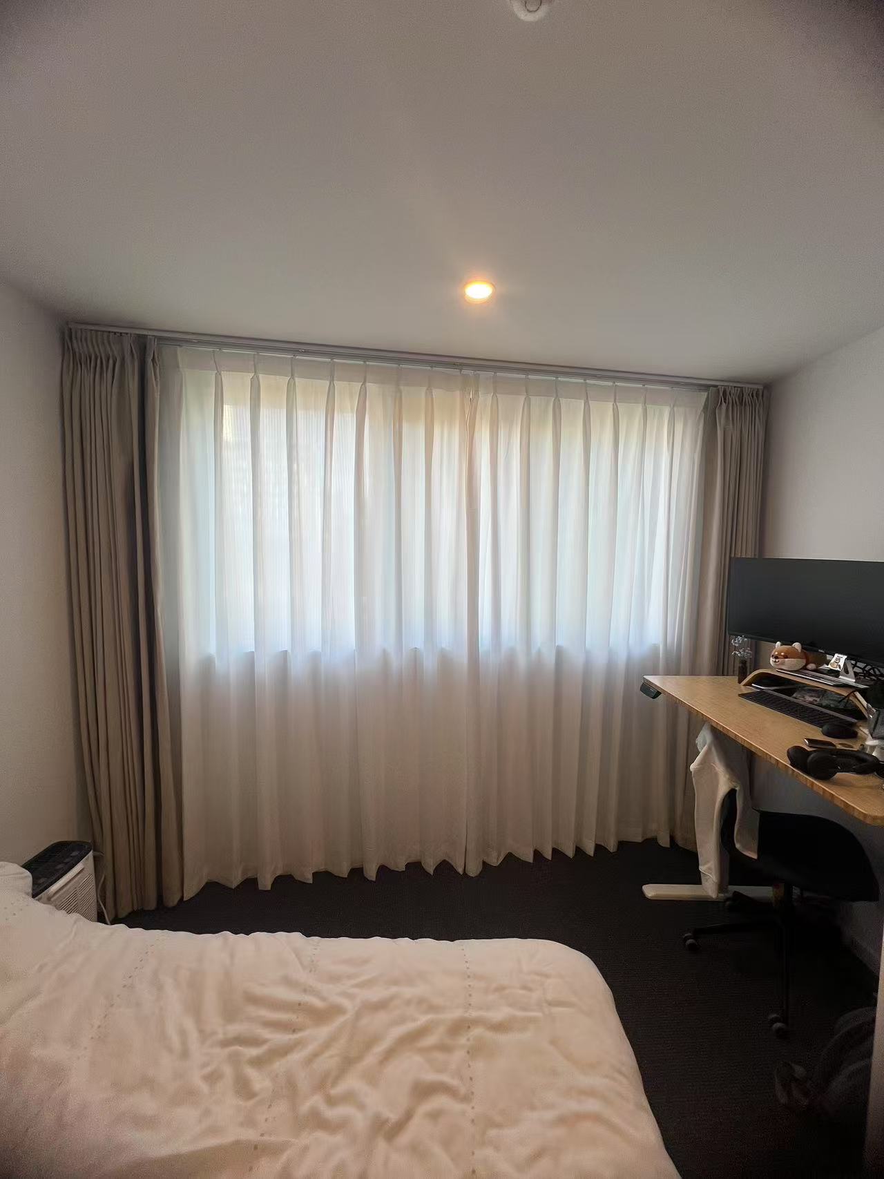 Installed brown pinch blockout curtain and pinch privacy sheer for one wondow in the bedro