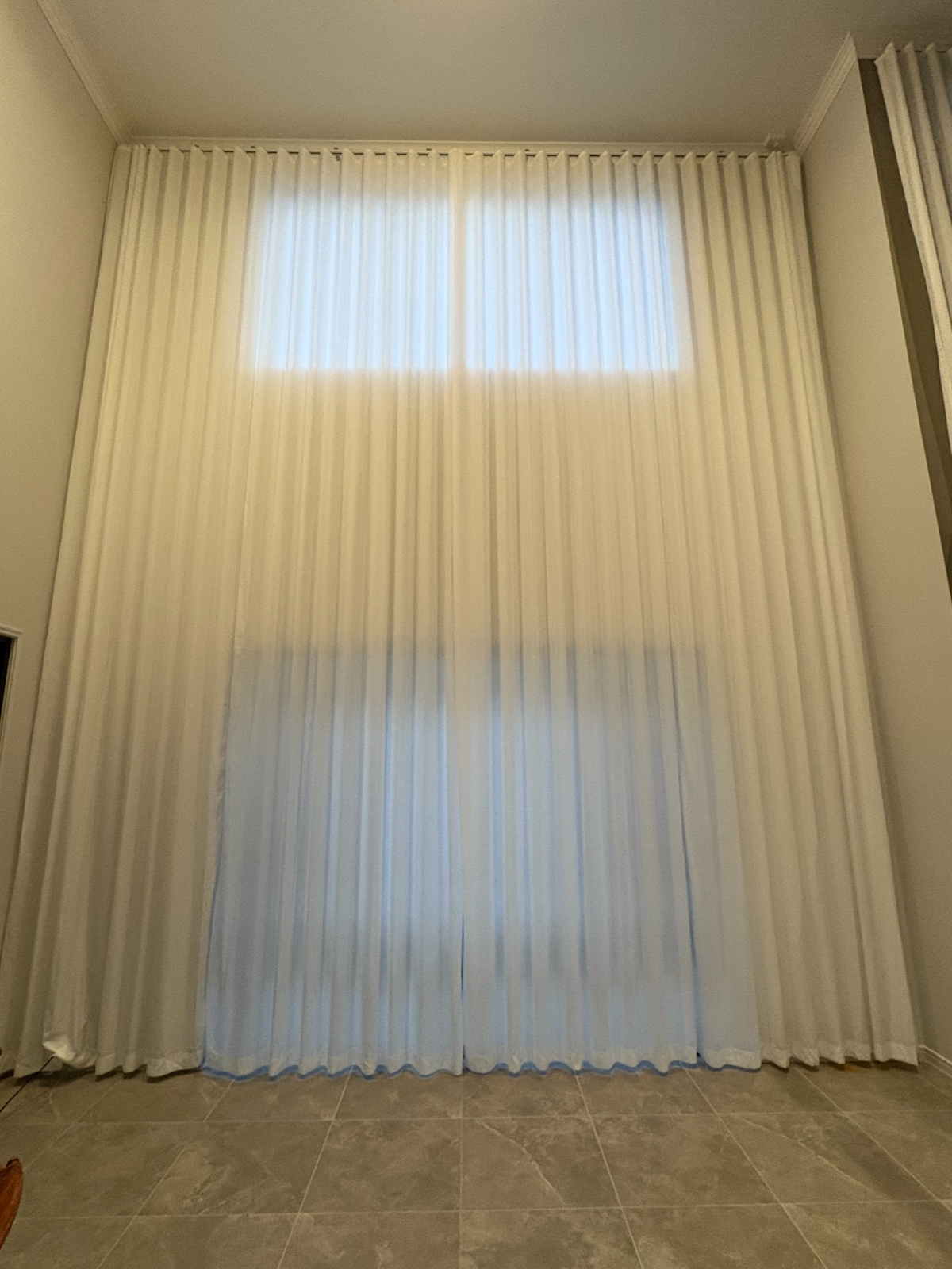 S-Fold privacy sheer installed for high window in living area