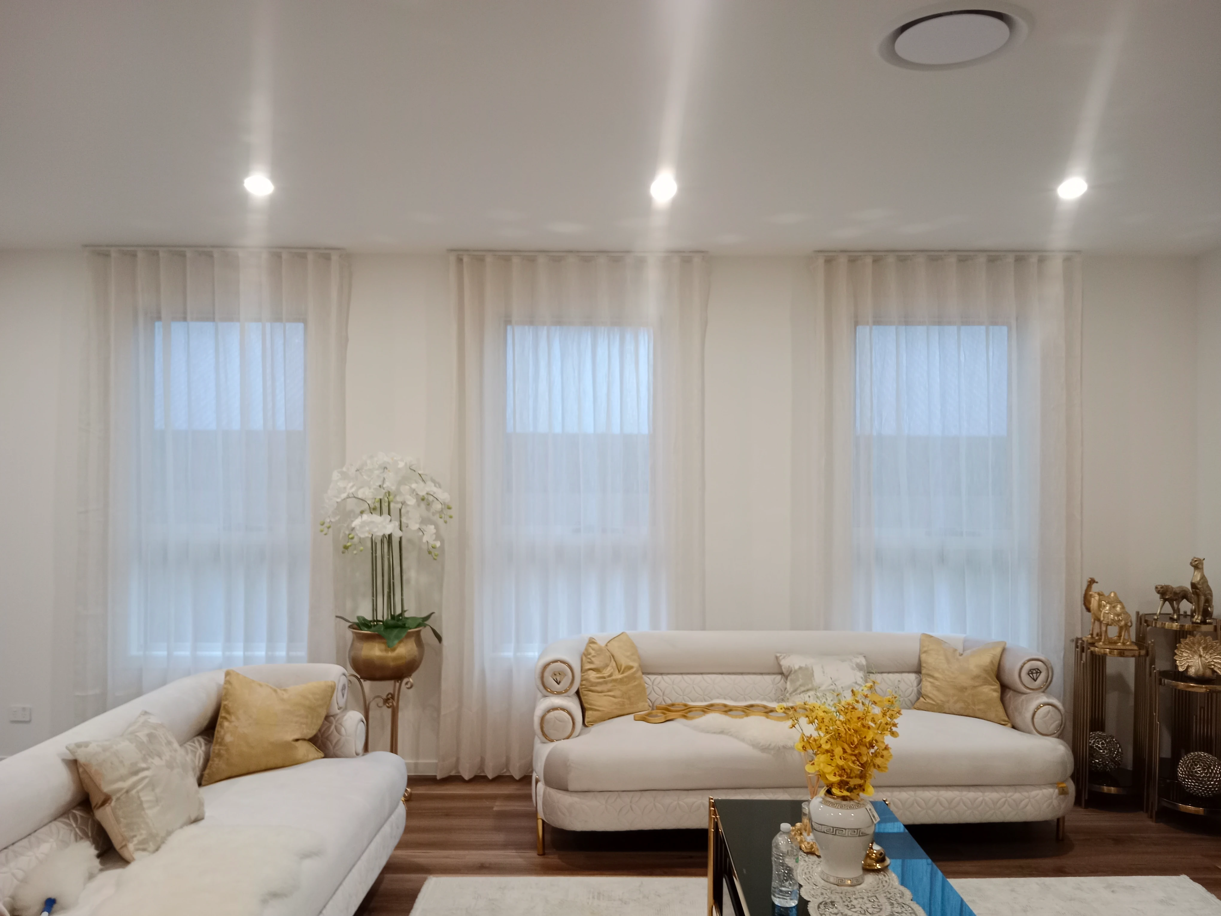 S-Fold transparent sheers installed for three windows in living area