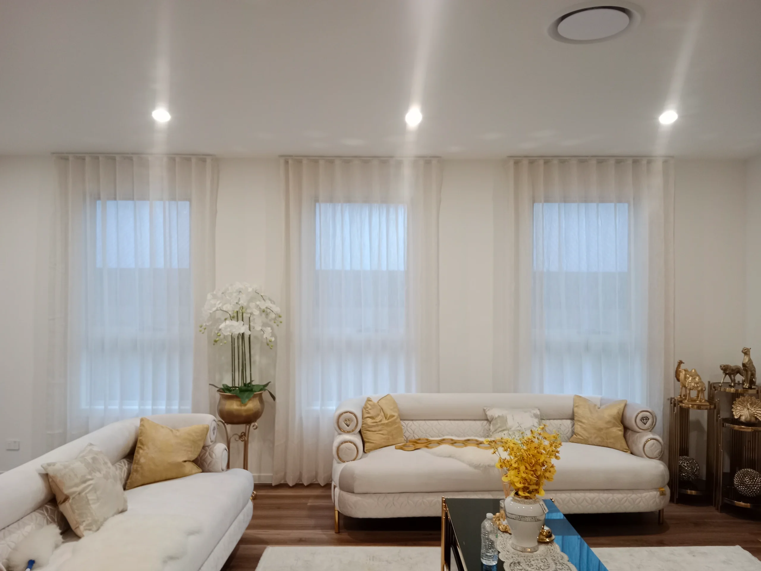 S-Fold transparent sheers installed for three windows in living area