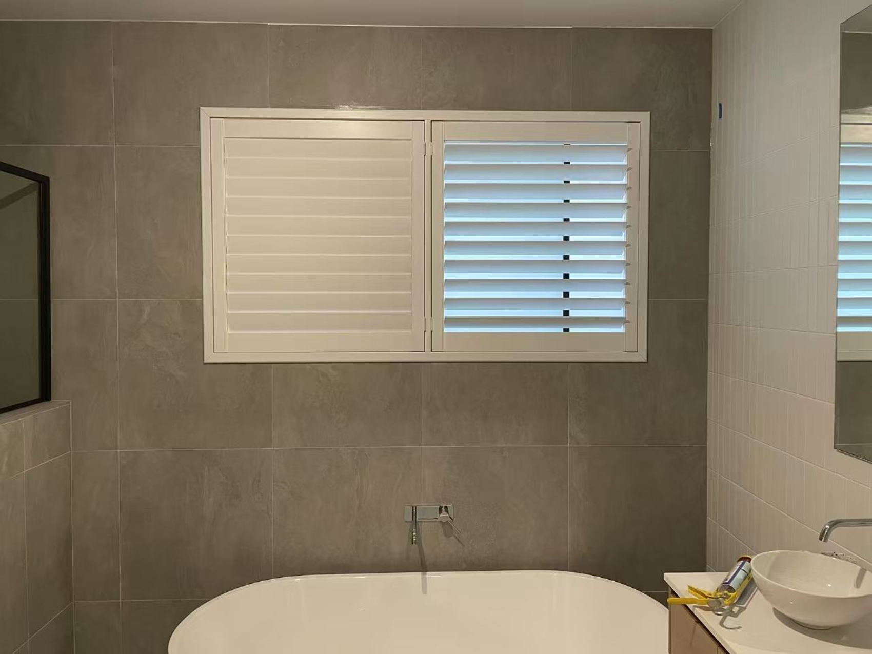 PVC plantation shutters installed for one window in the bathroom