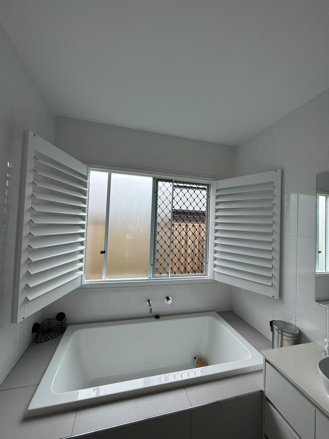 Plantation shutter installed for one window with double open way in bathroom