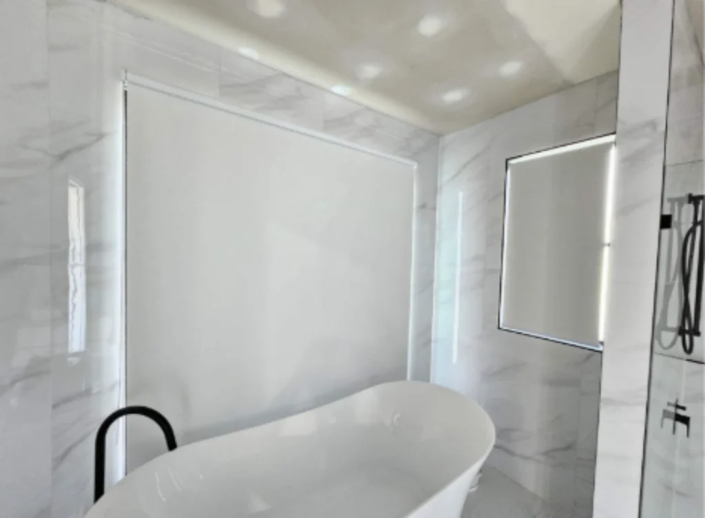 White blockout roller blind fitted neatly inside a window recess