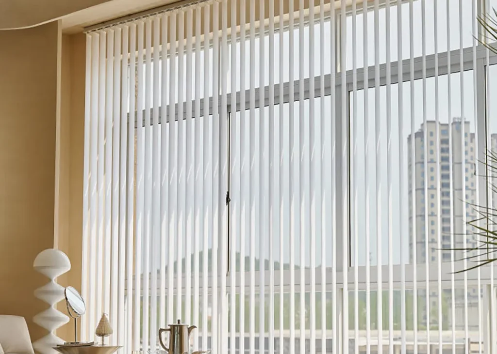 Floor-to-ceiling vertical blinds across a large window with a city view in an Auckland apartment