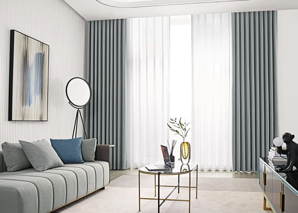 Blue-grey blockout curtains layered behind white sheers on a double track
